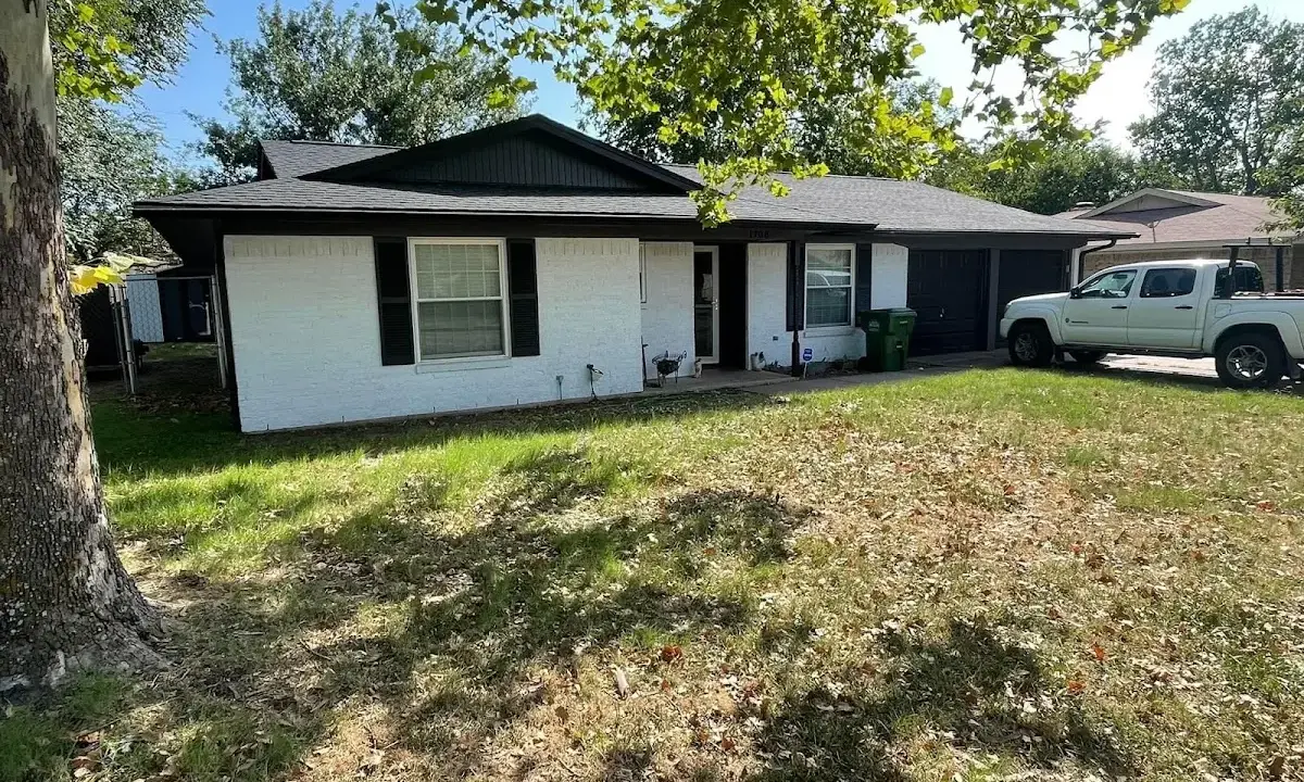 Professional roofing crew working on a residential roof in Carney